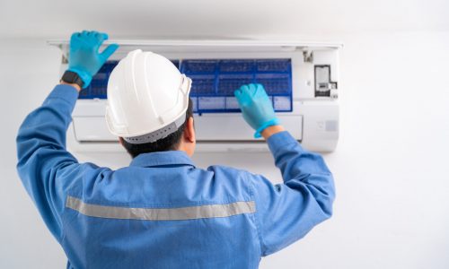 Air technician service cleaning air conditioner indoors. Service concept of an air conditioner technician.