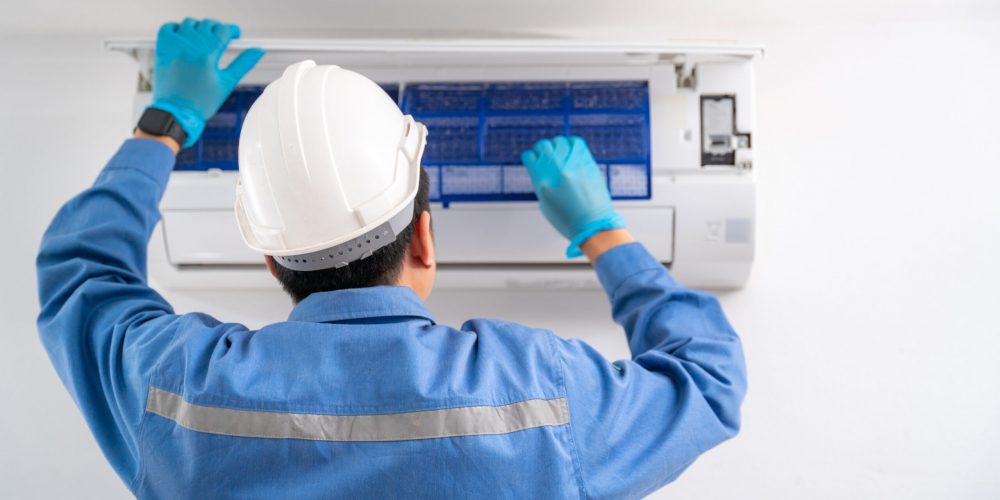 Air technician service cleaning air conditioner indoors. Service concept of an air conditioner technician.